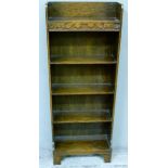 An oak book case with three quarter gallery to the upper section, shelved below, 46cm wide x 122.5cm