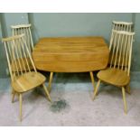 An Ercol beech drop leaf dining table on tapered splayed legs and four rail back dining chairs,