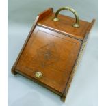 A Victorian walnut coal scuttle with brass reeded handle