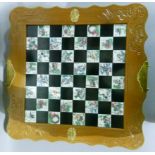 A chess board with drawers containing a chess set