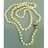 A cultured pearl necklace, the graduated pearls fastened with a 9ct gold pearl and amethyst set