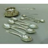 A silver tea strainer with rocaille & foliate cast rim and handle, Sheffield 1902 and an