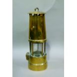 A brass miners lamp stamped serial number 5456L