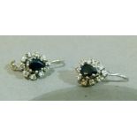 A pair of sapphire and diamond cluster earrings c.1965 each claw set to the centre with a pear
