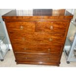 A Edward VII mahogany chest of two short and three long graduated drawers with brass quatrefoil back