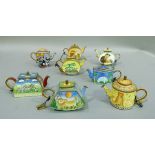 A set of eight handpainted enamelled miniature teapots decorated with various animals