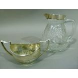 A silver two handled sugar bowl of half reeded design, Birmingham 1901 together with a cut glass