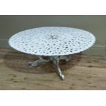 A white painted cast iron low set garden table, 99cm diameter