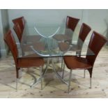A glass top table on metal frame with a set of six moulded leather style dining chairs on tubular