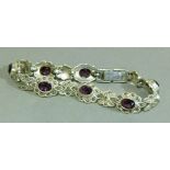 A silver bracelet each cluster link set with marcasite and purple oval faceted paste, approximate