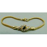 A bracelet in 9ct gold foxtail links set to the centre with a cluster sapphire and cubic zirconia,
