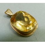 A citrine pendant in 9ct gold collet set within twisted wire surround, approximately 19mm x 13mm,
