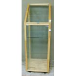 A display cabinet with sloping top, glass shelved interior, 46cm wide x 138cm high
