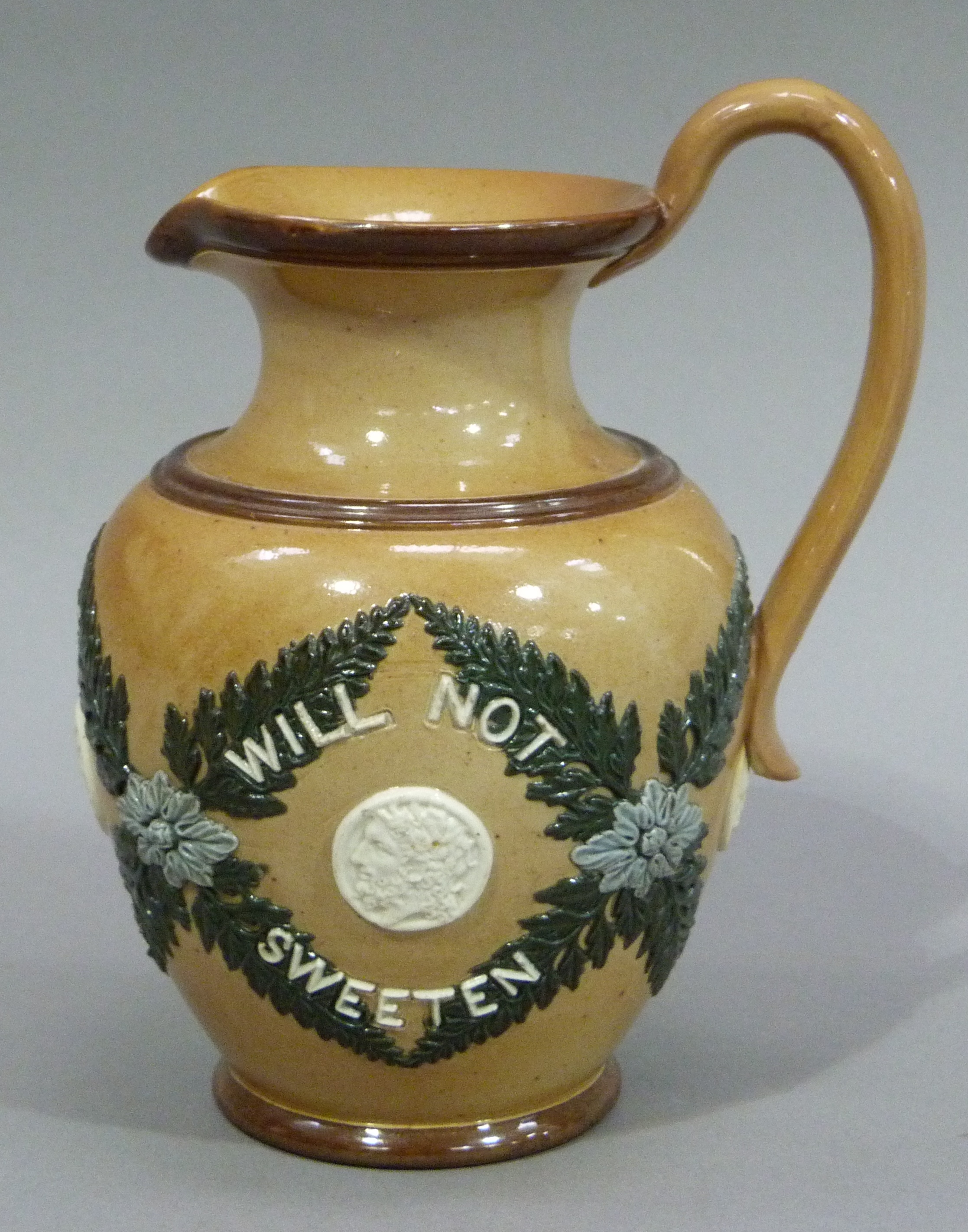 A Doulton Lambeth stoneware jug, 'Bitter must be the Cup' 17cm high