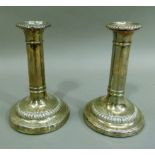 A pair of late George III silver candlesticks with detachable sconces, ring turned columns,