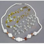 A yellow and clear graduated bead necklace interspersed with Vaseline seed shaped beads as a three