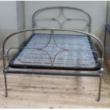 A pewter coloured metal double bedstead of Victorian style, with springs