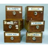 Six mahogany fronted drawers from a chemist cabinet each labelled five with glass fronts, glass