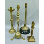 A Victorian brass candlestick converted to electricity with loop handle, lobed and dished base on