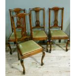 A set of four 18th century style dining chairs with pierced splat upholstered drop in seat and on