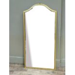 A gilt framed wall mirror of arched rectangular outline, 124cm high x 62cm wide
