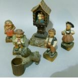Two pair of Black Forest miniature figures, one as an old couple the other as a boy and girl in