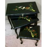 A nest of three rectangular tables the black ground painted in the chinoiserie style with birds