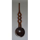 A treen ladle with open work decoration, 50cm long