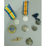 A group of medals and badges including 1939-45 General Service and Defence medals with associated