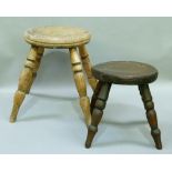 Two 19th century wooden milking stools, circular tops and turned legs, 29cm high and smaller