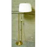 A gilt metal reading lamp with cream shade