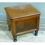 A Victorian mahogany commode with indented panel front and on turned legs the interior with armrests