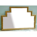 A modern wall mirror of stepped outline with the centre rectangular panel, bevelled and flanked by