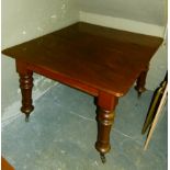 A Victorian mahogany extending dining table the rounded rectangular figured top with two