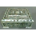 A mother of pearl casket the hinged lid centered with a raised tablet and a domed building in low