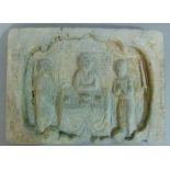A Chinese terracotta plaque moulded in relief with three figures within a shaped cartouche, 24cm x
