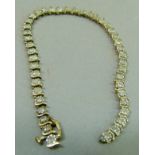 A diamond set bracelet (a/f) the brilliant cut stones claw set inline in yellow metal (tests as