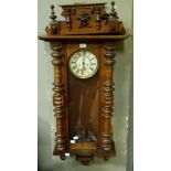 A Vienna walnut veneered wall clock with ornate cornice the cream dial with blued steel hands and