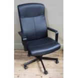 An executive style office chair with swivel base