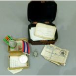 A lacquer box containing 1939-1945 general service and defence medal with associated packaging for H