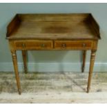A Victorian mahogany wash stand having a three quarter gallery above two drawers to the apron,