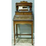 An Edwardian writing desk in mahogany inlaid with satinwood banding having a raised back with mirror