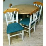 A pine topped kitchen table on cream painted base together with a set of four cream painted