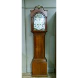 A 19th century oak long cased clock having an arched dial painted with thatched cottages and figures