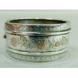 A Victorian silver stiff hinged bangle engraved and applied foliate rose and yellow gold flower