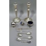 A pair of silver candlesticks, circular silver open salt with blue glass liner, a mustard pot with