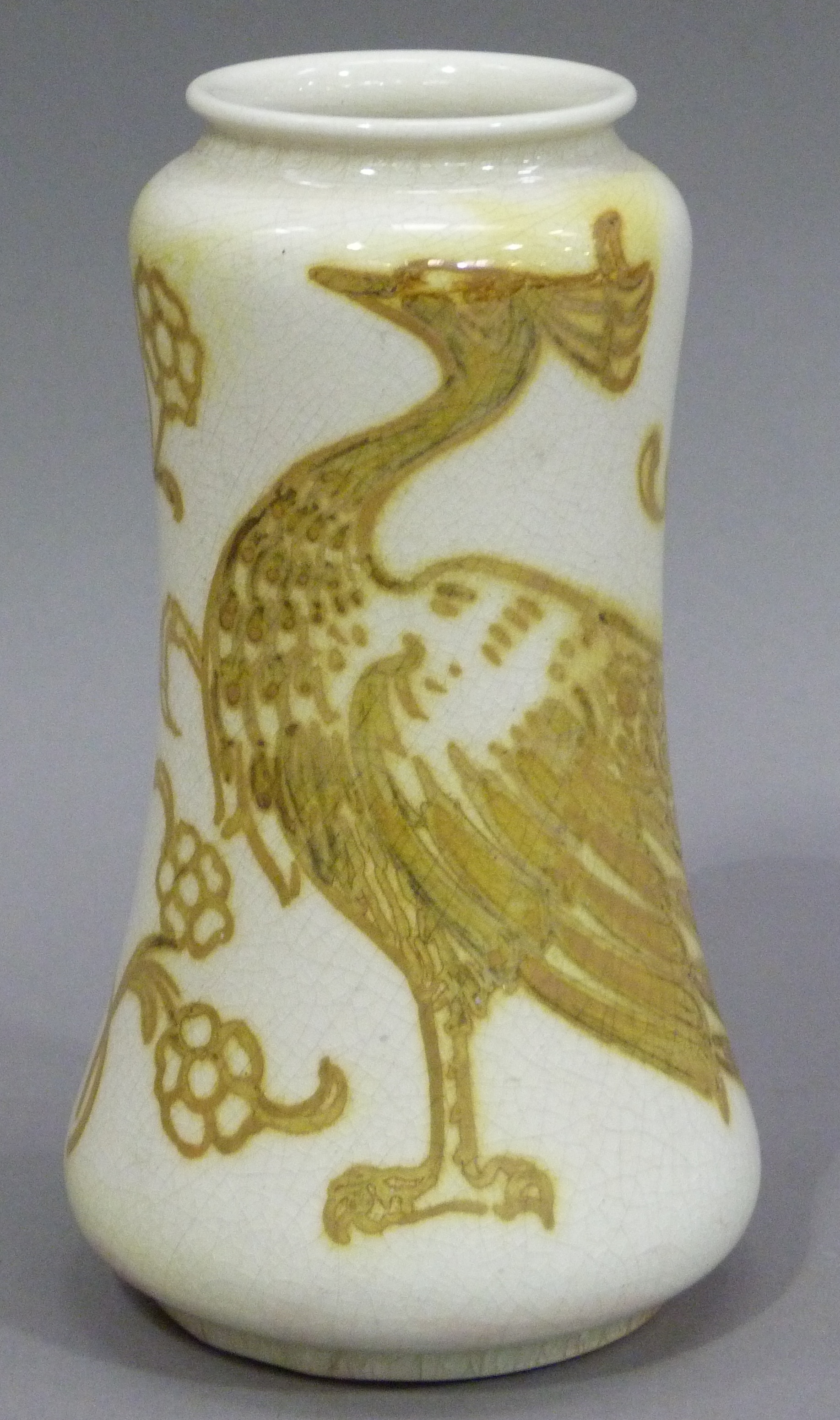 A Burmantofts vase, the pale body painted in yellow and gilt lustre with a peacock, impressed mark