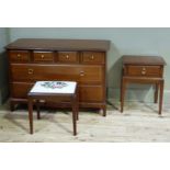 A Stag minstrel dressing chest of three heights, a Stag bedside table and a stool