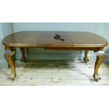 A mahogany extending table, wind out mechanism cabriole legs on claw and ball feet with later