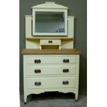 A pale yellow painted wooden dressing table, the bevelled plate supported on a pair of Art Nouveau